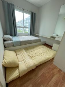 a bedroom with a bed and a window at Hua hin The Trust condo by Wila in Hua Hin