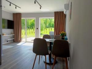 a dining room with a table and some chairs at Domki Szychówka in Szczawina