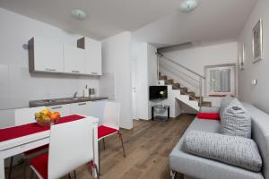 a kitchen and living room with a couch and a table at Apartmani Ve-Ro in Opatija