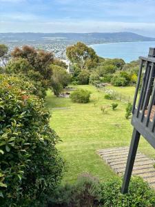 a bench sitting on top of a field of grass at Mt Martha - Mar Vista - Panorama views with Modern coastal style in Mount Martha
