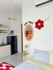 a bedroom with a bed and a kitchen at Corgi House Central Nha Trang in Nha Trang