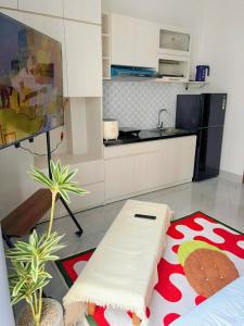 a kitchen with a table and a couch in a room at Corgi House Central Nha Trang in Nha Trang +16 photos