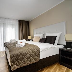 ein großes Schlafzimmer mit einem großen Bett mit weißer Bettwäsche in der Unterkunft Landhaus Ambachhof in Oetz