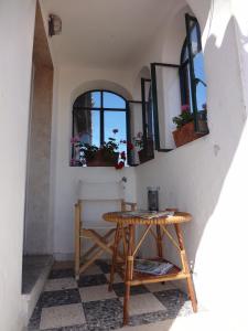 a table in a room with windows and plants on the wall at Torrione San Giovanni I in Terracina