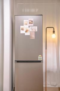a stainless steel refrigerator with pictures on it at Sillim Queen House in Seoul
