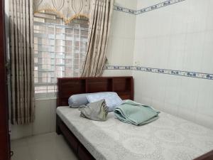 a bedroom with a bed with two bags on it at Hải Yến in Ba Ha