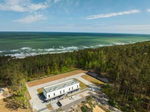 an aerial view of a building with the ocean at NA WYDMIE Apartments&Camp in Dziwnówek +12 photos