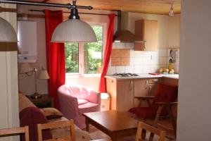 a kitchen and a living room with a table at Chateau-camping la Grange Fort, 63500 Les Pradeaux in Les Pradeaux