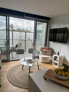 a living room with a view of a living room at Centrepoint Units Heidelberg in Melbourne