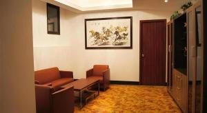 a waiting room with chairs and a couch and a painting at GreenTree Inn Shanghai South Railway Station Xujiahui Stadium Subway Station Shell Hotel in Shanghai