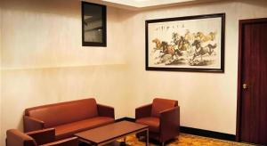 a waiting room with a couch and a table at GreenTree Inn Shanghai South Railway Station Xujiahui Stadium Subway Station Shell Hotel in Shanghai