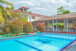 an image of a swimming pool in front of a house at Hotel Water Nest in Etagama