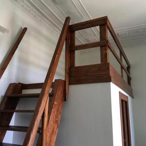 a wooden staircase in a room with a ceiling at Appartamento Esmeralda in Tortoreto Lido