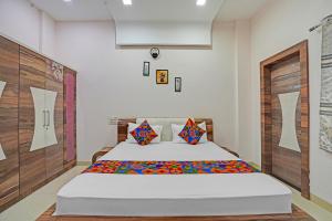 a bedroom with a bed in a room at FabExpress Kaveri Executive - Nr Alandi vithoba temple in Pune