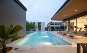 a swimming pool in the middle of a house at The Moment in Bangkok
