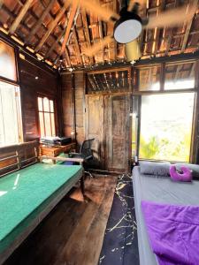 a room with two beds and a window at My Kubu in Jembrana