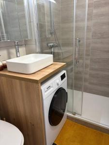 a washing machine in a bathroom with a shower at Ondine in Gruissan +15 photos