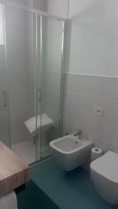 a bathroom with a shower and a sink and a toilet at Appartamento I Delfini in Gabicce Mare