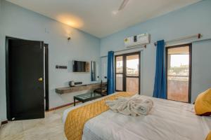 a hotel room with a bed and a bathroom at Corbelli Residency in Puducherry