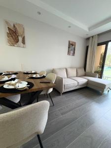 a living room with a table and a couch at Chez Maïsa - Vue sur mer in Flic-en-Flac