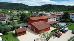 an aerial view of a small village with a red house at Dolcevita guest house in Torreano