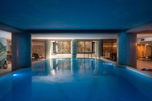 a large swimming pool in a hotel room at The Nicolaus Hotel in Bari