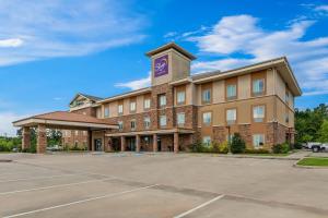 an image of a hotel with a parking lot at MainStay Suites Lufkin in Lufkin