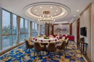 a dining room with a table and chairs at Golden Sea View Hotel Haikou in Haikou