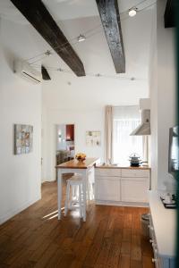 a kitchen with a wooden table in a room at Rudolfo Hotel in Lviv