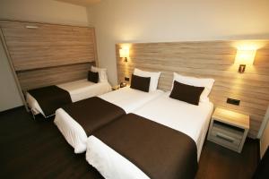 Voodi või voodid majutusasutuse Hotel Pyrénées toas