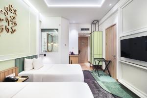 Luwansa Hotel and Convention Center Manado客房内的一张或多张床位