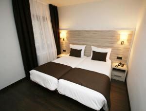 Voodi või voodid majutusasutuse Hotel Pyrénées toas