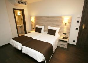 Voodi või voodid majutusasutuse Hotel Pyrénées toas