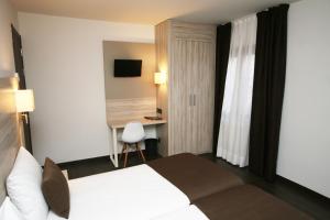 Voodi või voodid majutusasutuse Hotel Pyrénées toas