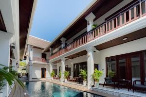 an exterior view of a villa with a swimming pool at Cozy An Luangprabang Hotel in Luang Prabang
