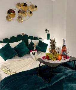 a room with a bed with a tray of fruit on a table at Bella Vista in Balíon