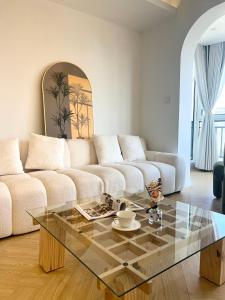 a living room with a couch and a glass table at Urban Hub Near the Bund nice view big apartment 2bathrooms in Shanghai