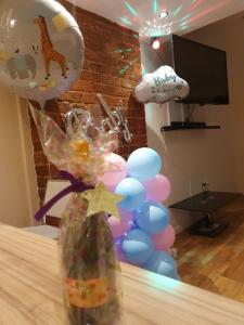 a bunch of balloons and a vase with a bunch of balloons at Infinity Partypadsliverpool Hen And Stag Welcome in Liverpool