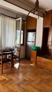 a living room with a table and chairs and a kitchen at Cozy Room with Host in Tbilisi City