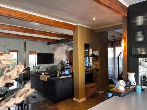 a living room with a desk in a room at Modern Retreat at Hout Bay Beach in Hout Bay