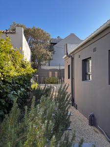 a side view of a house with a yard at Modern Retreat at Hout Bay Beach in Hout Bay