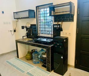 a kitchen with a stove and a sink at Thiago living Syariah in Jakarta