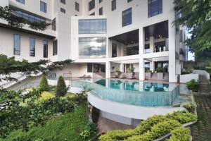 美娜多Luwansa Hotel and Convention Center Manado的带游泳池的建筑外观