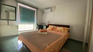 a bedroom with a bed with a towel on it at Cozy Corner Zrenjanin in Zrenjanin