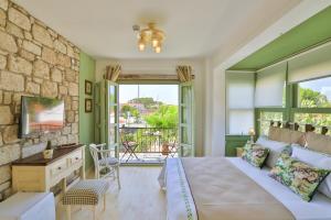a bedroom with a large bed and a balcony at Palas Alaçatı - Adult Only in Alacati