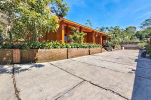 a house with a fence and a sidewalk at RedDoorz near Kopeng Salatiga 