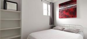 a bedroom with a bed and a red painting on the wall at Strasbourg Centre et Parlement in Strasbourg
