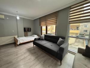 a living room with a couch and a bed at SİMGE Apt in Trabzon