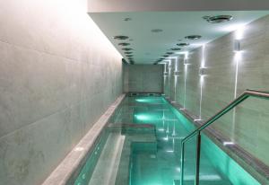 a swimming pool with green water in a building at Spa Hotel Persenk in Devin +46 photos