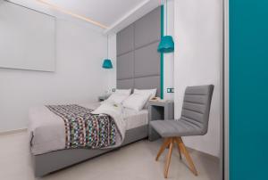 a bedroom with a bed and a desk at Sweet Pop in Fira